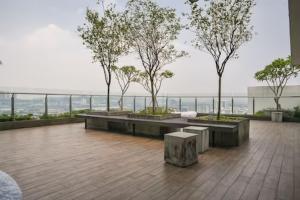 a balcony with benches and trees on top of a building at Sunway /Usj one Residence/ CozyHome/2bed room/2 Bath in Subang Jaya