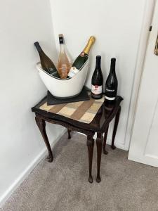 a table with a bucket of wine bottles on it at 4 bed countryside home near Solihull & NEC - Sleeps 8 in Solihull