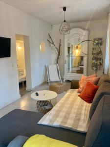 a living room with a couch and a table at Au pied du luberon in Pertuis