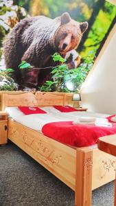 a wooden bed with a picture of a bear on it at Willa na górskim szlaku in Małe Ciche