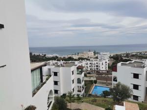 a view of a city with white buildings and the ocean at Résidence Bella Vista Cabo Negro in Cabo Negro