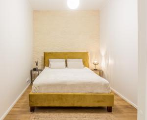 a bedroom with a large bed with white sheets at Old Town Deluxe Apartment in Tartu