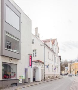 a white building on the side of a street at Old Town Deluxe Apartment in Tartu