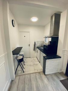 a kitchen with a counter and a table and a sink at Luxury Apartments Paris in Le Bourget