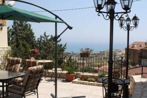 a patio with a table and chairs and an umbrella at Bed and Breakfast Don Angelo Miramare in Realmonte +17 photos
