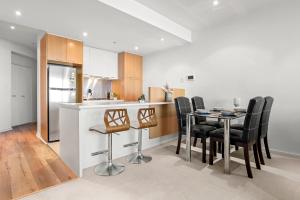 a kitchen and dining room with a table and chairs at Sea View, Gym & Pool, 2 bedrooms 2 bathrooms in Melbourne