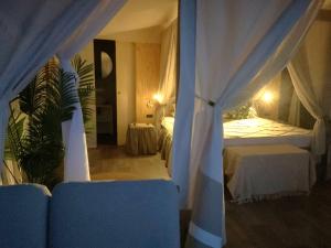 a bedroom with two beds with curtains and a table at Luxury Lodge in Bellagio