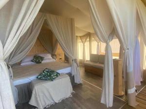 a bedroom with a canopy bed and a couch at Luxury Lodge in Bellagio