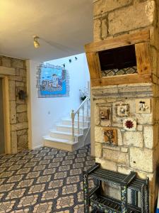 a room with a stone wall and a staircase at Alacati Zeynep in Alacati