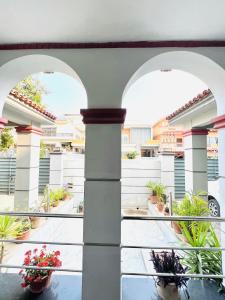 a courtyard with two arches and potted plants at Family Lodges in Islamabad