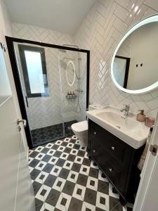 a bathroom with a toilet and a sink and a mirror at La Repera in Palamós