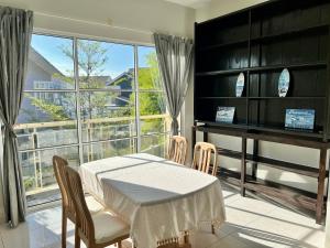 a dining room with a table and a piano at Garden Homestay Kuala Terengganu in Kuala Terengganu