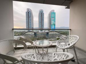a balcony with tables and chairs and views of buildings at Centaurus Facing Executive Apartments By Elysium Tower Islamabad in Islamabad