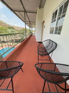 einen Balkon mit 2 Stühlen und einem Tisch in der Unterkunft Keona Beach in La Libertad