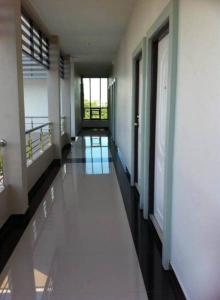 a hallway of a building with white walls and floors at The Room Nangrong in Nang Rong