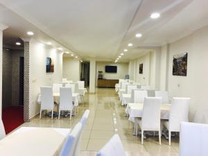AkcaabatにあるLarok Hotelの白いテーブルと白い椅子が備わる会議室