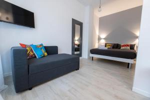 a living room with a couch and a mirror at Cà Cianfer in Bergamo