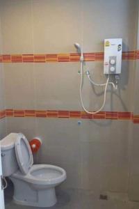 uma casa de banho com um WC branco e um chuveiro em The Room Nangrong em Nang Rong