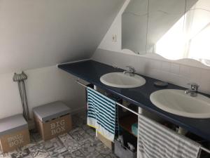 a bathroom with two sinks and a large mirror at Maison Hoëdic in La Trinité-sur-Mer +8 photos