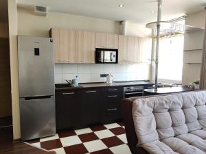 eine Küche mit einem Kühlschrank und einer Arbeitsplatte in der Unterkunft Apartments near BIG in Vilnius