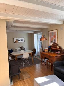 a living room with a table and a dining room at Tidligere stall omgjort til koselig hjem i sentrum in Tromsø