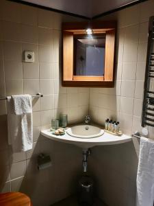 a bathroom with a sink and a mirror at Casa do Pombal in São Mateus