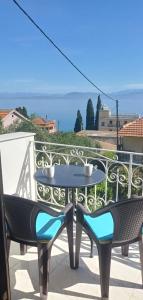 a table and two chairs sitting on a balcony at FLORA STUDIOS CORFU - Adults only in Benitses