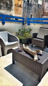 a patio with a table and chairs and plants at Il Borgo Trapanese in Trapani
