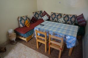a living room with a table and a couch at SamIfrane1 in Zaouia dʼIfrane