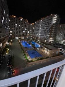 a view of a pool from a balcony at night at New Cozy Studio Apartment in Marigondon