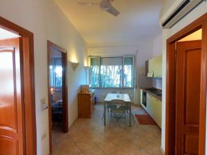 a kitchen with a table and a dining room at Villa Emilia appartments in Cala Gonone