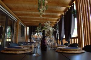 a table with wine glasses and flowers on it at Mobile home - EXCLUSIVE in Biograd na Moru