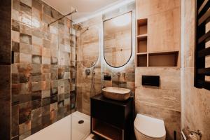 a bathroom with a sink and a toilet at Coś miłego in Gowidlino