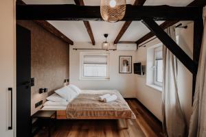 a bedroom with a bed and a window at Coś miłego in Gowidlino