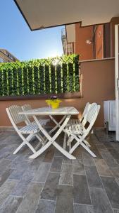a white table and chairs on a patio at Zefiro Ostia in Lido di Ostia