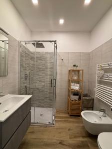 a bathroom with a shower and a sink and a tub at ZEFIRO OSTIA-Free parking & Terrace in Lido di Ostia +41 photos