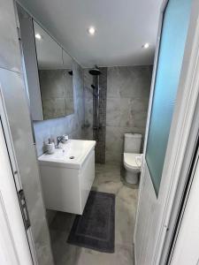 a bathroom with a sink and a toilet at Harmony Apartments in Dhërmi +23 photos