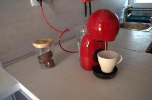 a red blender sitting on a counter with a cup at Mobile home - EXCLUSIVE in Biograd na Moru