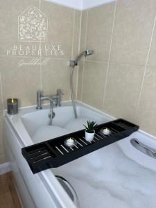 a bath tub with a sink with a plant in it at Guildhall - Beauluxe Properties large property - 3 bedroom - 4 beds - sleeps upto 6 people in Church Gresley