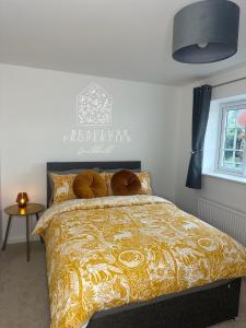 a bedroom with a bed with a yellow comforter at Guildhall - Beauluxe Properties large property - 3 bedroom - 4 beds - sleeps upto 6 people in Church Gresley