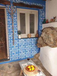 a room with blue walls and a table with a bowl of oranges at Casa Carrie in Válor