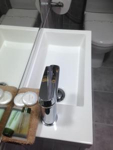 a sink with a faucet in a bathroom at Beachcomber Motel & Apartments in Apollo Bay