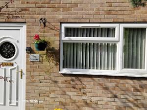 a window on a brick house with a white shutter at The Annexe in Bridlington