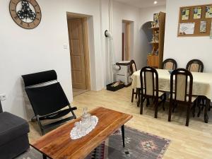 a living room with a table and chairs at Zselic Kapuja Vendégház in Kaposszerdahely