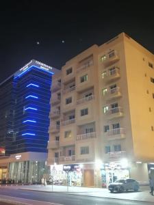 a building with a car parked in front of it at Pharaohs Inn MOE Hostel in Dubai