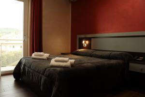 a bedroom with a bed with towels on it at Hotel Paradiso in Falerna