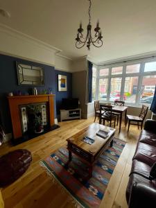 a living room with a couch and a table at A cosy garden flat in a quiet area close to the city centre in Bristol
