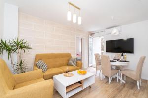 a living room with a couch and a table at Star Apartments Dubrovnik in Dubrovnik