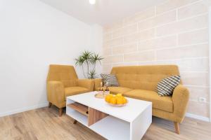 two chairs and a coffee table in a living room at Star Apartments Dubrovnik in Dubrovnik