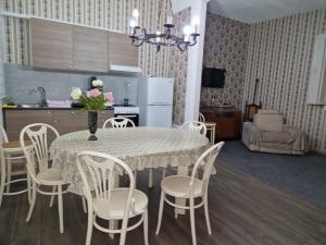 a dining room table with a vase of flowers on it at Milner Flats in Sliema +10 photos